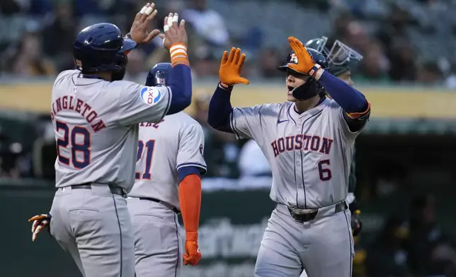 Houston Astros' Jake Meyers (6) celebrates with Jon Singleton after hitting a three-run home run against the Oakland Athletics during the fourth inning of a baseball game Friday, May 24, 2024, in Oakland, Calif. (AP Photo/Godofredo A. Vásquez)