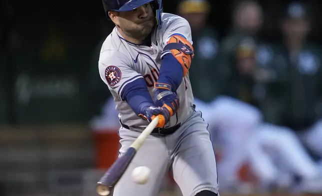Houston Astros' Jose Altuve hits a single against the Oakland Athletics during the fourth inning of a baseball game Friday, May 24, 2024, in Oakland, Calif. (AP Photo/Godofredo A. Vásquez)