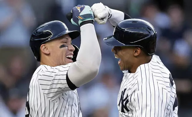 New York Yankees' Juan Soto celebrates with Aaron Judge, left, after hitting a two-run home run against the Houston Astros during the first inning of a baseball game Wednesday, May 8, 2024, in New York. (AP Photo/Adam Hunger)