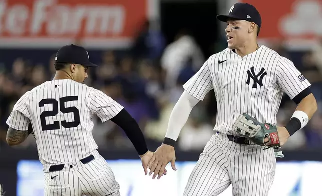 New York Yankees outfielder Aaron Judge celebrates with Gleyber Torres (25) after the Yankees defeated the Houston Astros in a baseball game Wednesday, May 8, 2024, in New York. (AP Photo/Adam Hunger)