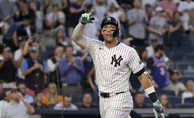 New York Yankees' Aaron Judge gestures after hitting a home run against the Houston Astros during the third inning of a baseball game Wednesday, May 8, 2024, in New York. (AP Photo/Adam Hunger)