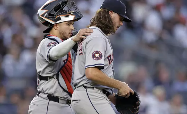 Houston Astros catcher Yainer Diaz, left, talks to pitcher Spencer Arrighetti after New York Yankees' Anthony Volpe walked to load the bases during the second inning of a baseball game Wednesday, May 8, 2024, in New York. (AP Photo/Adam Hunger)