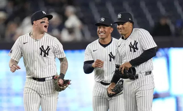 New York Yankees' Alex Verdugo, left, celebrates with Jahmai Jones, center, and Trent Grisham, right, after a baseball game against the Houston Astros, Tuesday, May 7, 2024, in New York. The Yankees won 10-3. (AP Photo/Frank Franklin II)