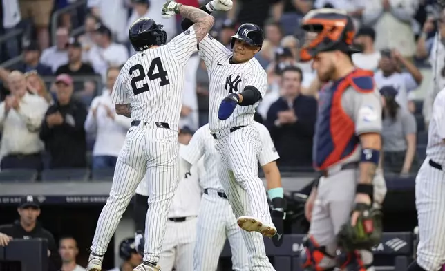 New York Yankees' Alex Verdugo, left, celebrates with Juan Soto, center, after hitting a three-run home run during the first inning of a baseball game against the Houston Astros, Tuesday, May 7, 2024, in New York. (AP Photo/Frank Franklin II)