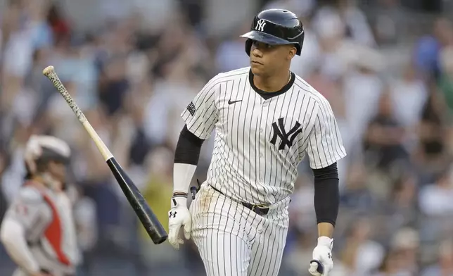New York Yankees' Juan Soto throws his bat after hitting a two-run home run against the Houston Astros during the first inning of a baseball game Wednesday, May 8, 2024, in New York. (AP Photo/Adam Hunger)