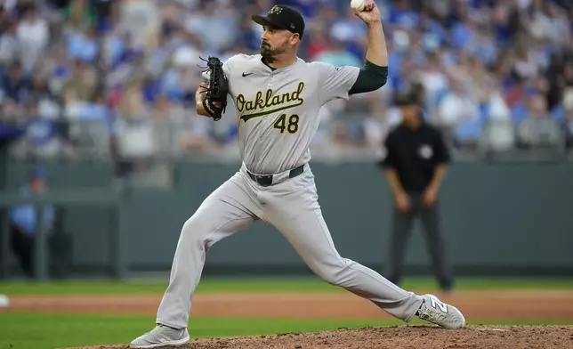 Oakland Athletics relief pitcher T.J. McFarland throws during the sixth inning of a baseball game against the Kansas City Royals Saturday, May 18, 2024, in Kansas City, Mo.(AP Photo/Charlie Riedel)