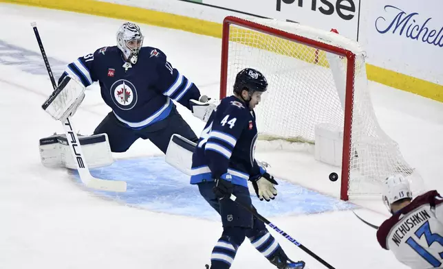 Colorado Avalanche Valeri Nichushkin (13) scores on Winnipeg Jets goaltender Connor Hellebuyck (37) during the first period in Game 5 of an NHL hockey Stanley Cup first-round playoff series in Winnipeg, Manitoba, Tuesday April 30, 2024. (Fred Greenslade/The Canadian Press via AP)