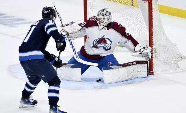 Colorado Avalanche goaltender Alexandar Georgiev (40) makes a save as Winnipeg Jets' Kyle Connor (81) looks for the rebound during the second period in Game 5 of an NHL hockey Stanley Cup first-round playoff series in Winnipeg, Manitoba, Tuesday, April 30, 2024. (Fred Greenslade/The Canadian Press via AP)