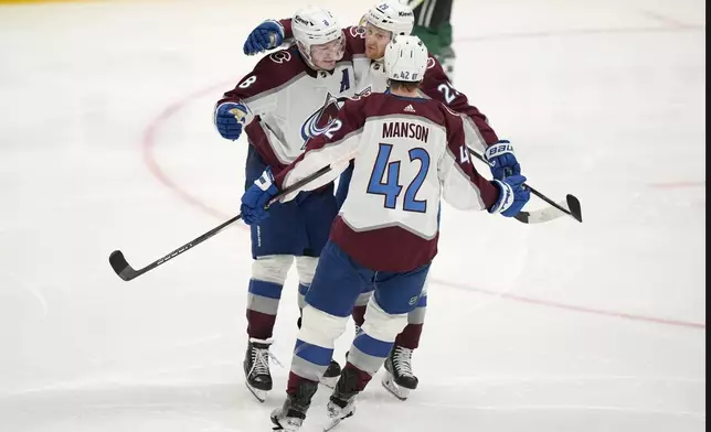 Colorado Avalanche's Josh Manson (42), Cale Makar (8) and Nathan MacKinnon (29) celebrate aftr Mackinnon scored in the third period in Game 2 of an NHL hockey Stanley Cup second-round playoff series against the Dallas Stars in Dallas, Tuesday, May 7, 2024. (AP Photo/LM Otero)