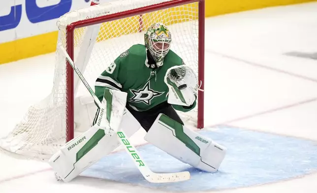 Dallas Stars goaltender Jake Oettinger gloves a shot from the Colorado Avalanche in overtime of Game 2 of an NHL hockey Stanley Cup second-round playoff series in Dallas, Tuesday, May 7, 2024. (AP Photo/LM Otero)
