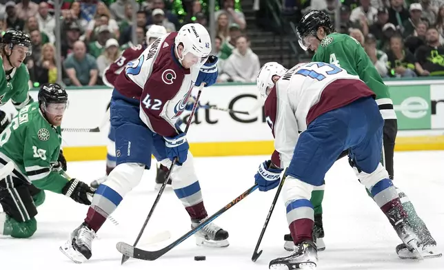 Colorado Avalanche defenseman Josh Manson (42) and right wing Valeri Nichushkin (13) attempt to clear the puck under pressure from Dallas Stars' Miro Heiskanen (4) and Joe Pavelski (16) during the first period in Game 2 of an NHL hockey Stanley Cup second-round playoff series in Dallas, Thursday, May 9, 2024. (AP Photo/Tony Gutierrez)