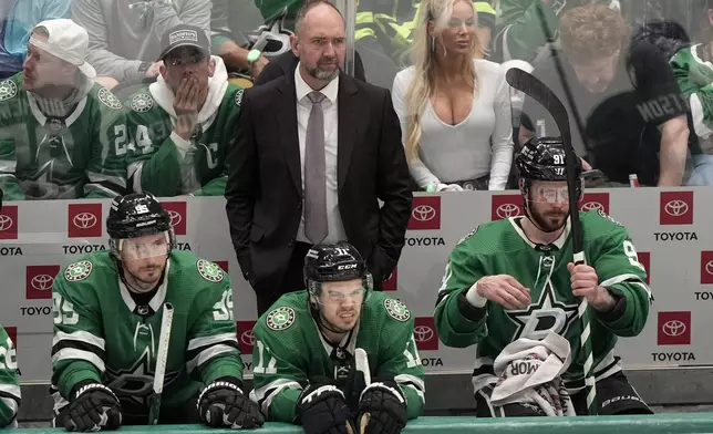 Dallas Stars head coach Pete DeBoer, center standing, Matt Duchene (95), Logan Stankoven (11) and Tyler Seguin (91) watch play in the third period in Game 2 of an NHL hockey Stanley Cup second-round playoff series against the Colorado Avalanche in Dallas, Tuesday, May 7, 2024. (AP Photo/LM Otero)
