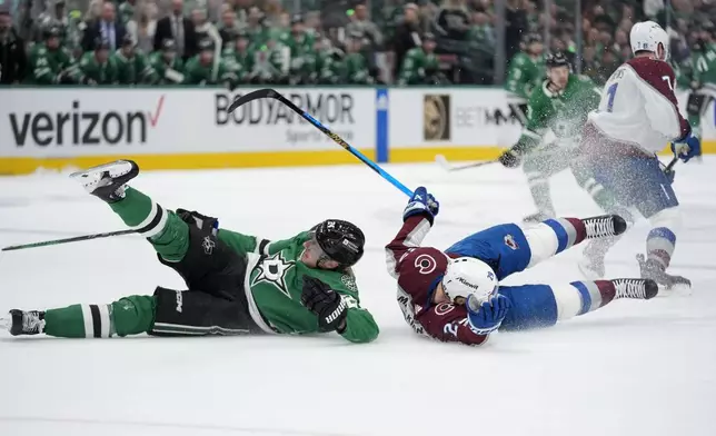 Dallas Stars' Roope Hintz (24) and Colorado Avalanche's Nathan MacKinnon (29) fall to the ice after colliding in the first period in Game 2 of an NHL hockey Stanley Cup second-round playoff series in Dallas, Tuesday, May 7, 2024. (AP Photo/LM Otero)
