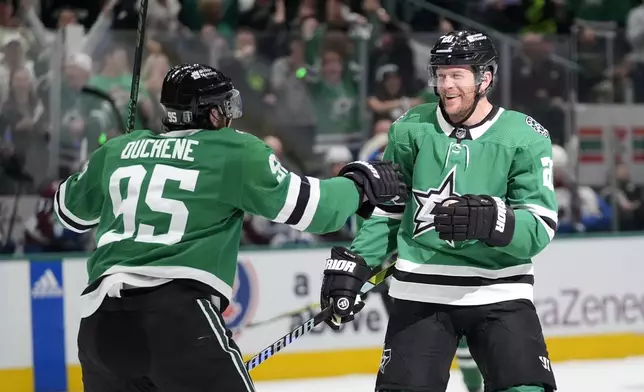 Dallas Stars' Matt Duchene (95) and Ryan Suter (20) celebrate after Suter scored in the first period in Game 2 of an NHL hockey Stanley Cup second-round playoff series against the Colorado Avalanche in Dallas, Tuesday, May 7, 2024. (AP Photo/LM Otero)