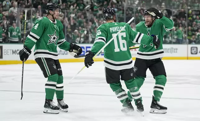 Dallas Stars center Joe Pavelski (16) celebrates his first period goal with Miro Heiskanen, left, and Ryan Suter in Game 5 of an NHL hockey Stanley Cup second-round playoff series against the Colorado Avalanche, Wednesday, May 15, 2024, in Dallas. (AP Photo/Tony Gutierrez)