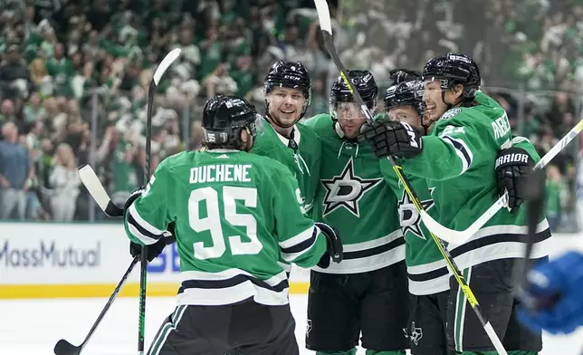 Dallas Stars players celebrate a goal by Joe Pavelski, center, during the first period in Game 5 of an NHL hockey Stanley Cup second-round playoff series against the Colorado Avalanche, Wednesday, May 15, 2024, in Dallas. (AP Photo/Tony Gutierrez)