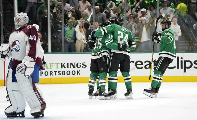 Dallas Stars' Joe Pavelski (16), Roope Hintz (24) and Jamie Benn (14) celebrate a goal by Miro Heiskanen against Colorado Avalanche goaltender Alexandar Georgiev (40) during the first period in Game 2 of an NHL hockey Stanley Cup second-round playoff series in Dallas, Thursday, May 9, 2024. (AP Photo/Tony Gutierrez)