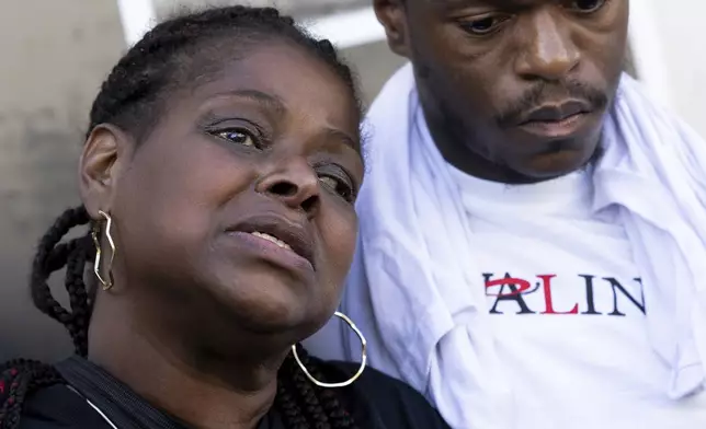 Antonio Moore comforts Antonio Lee's mother at a vigil for Lee, Friday, Aug. 18, 2023, in Baltimore. Lee, 19, was shot and killed while squeegeeing in Baltimore. (AP Photo/Julia Nikhinson)