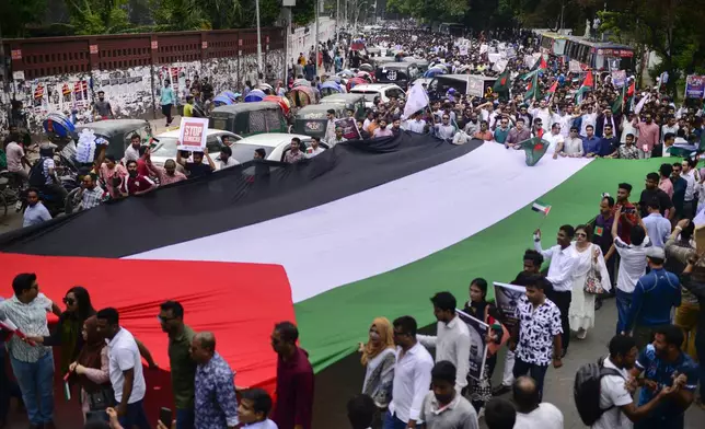 Bangladeshi students display a giant Palestinian flag, as they march during a pro- Palestinian demonstration at the Dhaka University area in Dhaka, Bangladesh, Monday, May 6, 2024. (AP Photo/ Mahmud Hossain Opu )