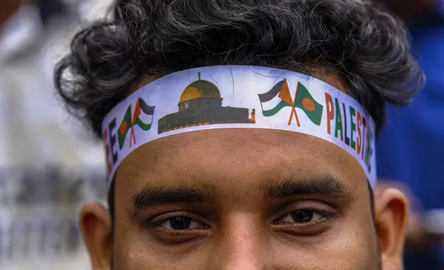 A student wearing headband looks on as Bangladeshi students march during a pro- Palestinian demonstration at the Dhaka University area in Dhaka, Bangladesh, Monday, May 6, 2024. (AP Photo/ Mahmud Hossain Opu )