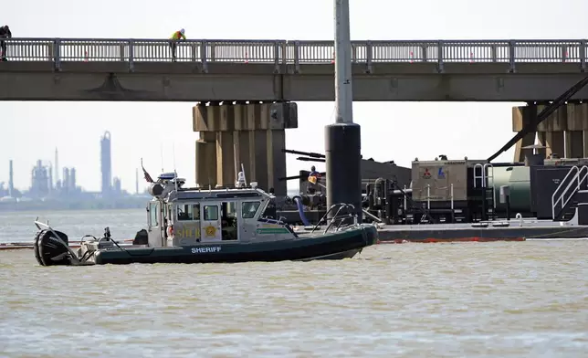 Officials patrol the waters at the site where a bardge crashed into the Pelican Island Bridge Wednesday, May 15, 2024, in Galveston, Texas. (AP Photo/David J. Phillip)