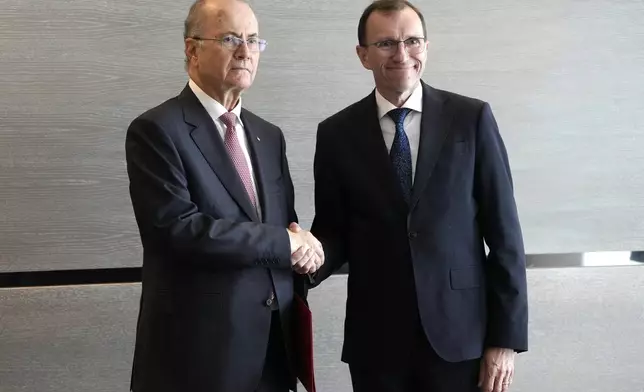 Prime Minister of the Palestinian Authority Mohammed Mustafa, left, shakes hands with Norway's Foreign Minister Espen Barth Eide prior to a meeting for talks on the Middle East in Brussels, Sunday, May 26, 2024. Norway on Sunday handed over papers to the Palestinian prime minister to officially give it diplomatic recognition as a state in a largely symbolic move that has infuriated Israel. (AP Photo/Virginia Mayo)