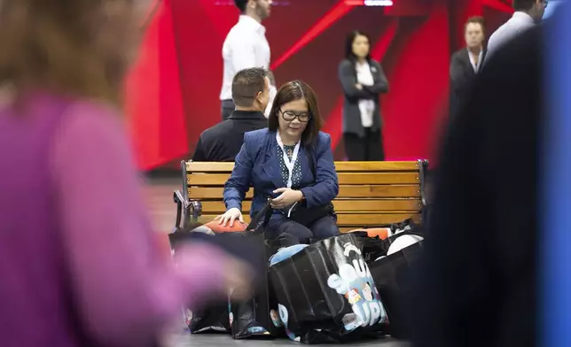 Jennifer Cua of Las Vegas sits with her purchases from Squishmallows during the Berkshire Hathaway annual meeting on Saturday, May 4, 2024, in Omaha, Neb. (AP Photo/Rebecca S. Gratz)