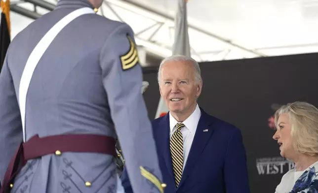 President Joe Biden, center, presents diplomas to graduating cadets at the U.S. Military Academy commencement ceremony, Saturday, May 25, 2024, in West Point, N.Y. (AP Photo/Alex Brandon)