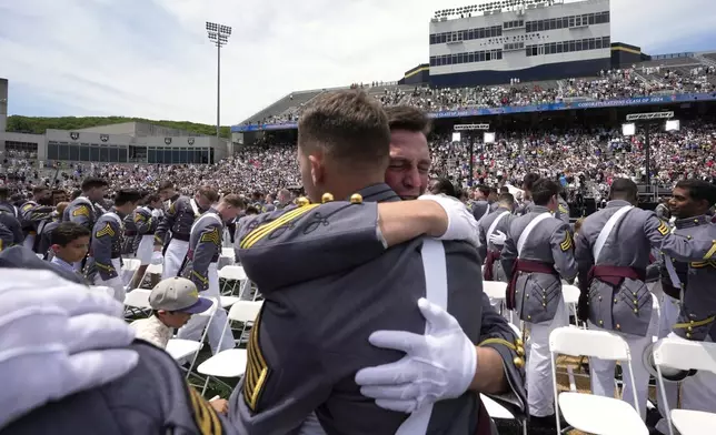 Graduates hug at the conclusion of the U.S. Military Academy commencement ceremony, Saturday, May 25, 2024, in West Point, N.Y. (AP Photo/Alex Brandon)
