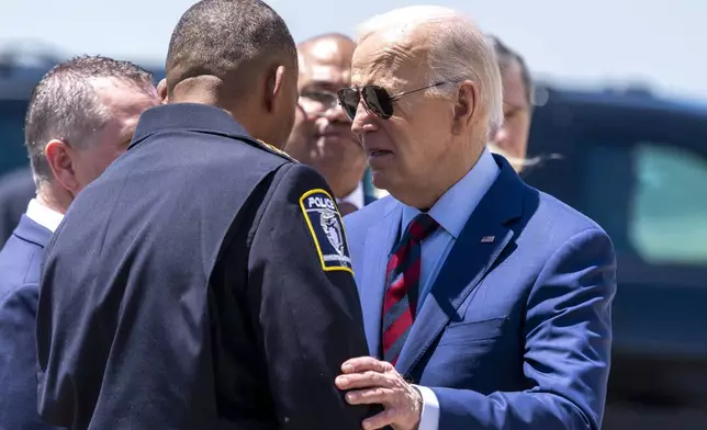President Joe Biden greets Charlotte-Mecklenburg Police Department Chief Johnny Jennings, as he arrives on Air Force One at Charlotte Douglas International Airport, Thursday, May 2, 2024, in Charlotte, N.C. Biden is meeting with the families of law enforcement officers shot to death on the job. (AP Photo/Alex Brandon)