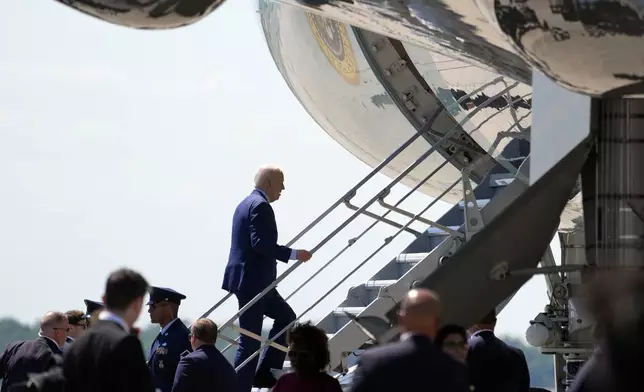 President Joe Biden boards Air Force One at Charlotte Douglas International Airport, Thursday, May 2, 2024, in Charlotte, N.C. Biden met with the families of law enforcement officers shot to death on the job. (AP Photo/Alex Brandon)