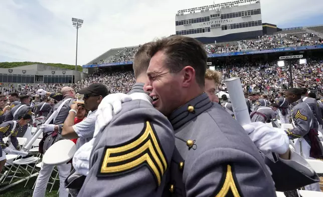 Class President Gary T Ward III, right, embraces a fellow graduate at the conclusion of the U.S. Military Academy commencement ceremony, Saturday, May 25, 2024, in West Point, N.Y. (AP Photo/Alex Brandon)