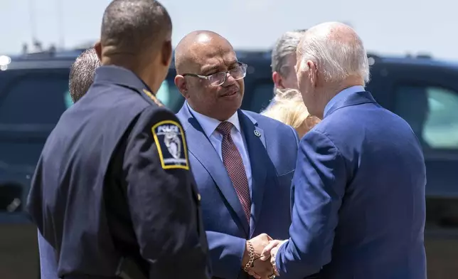 U.S. Marshals Service Director Ronald Davis, center, speaks with President Joe Biden, as he arrives on Air Force One at Charlotte Douglas International Airport, Thursday, May 2, 2024, in Charlotte, N.C. Biden is meeting with the families of law enforcement officers shot to death on the job. (AP Photo/Alex Brandon)