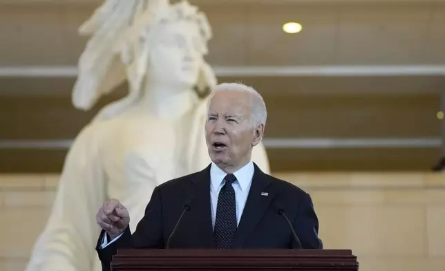 President Joe Biden speaks at the U.S. Holocaust Memorial Museum's Annual Days of Remembrance ceremony at the U.S. Capitol, Tuesday, May 7, 2024 in Washington. Statue of Freedom stands behind.(AP Photo/Evan Vucci)