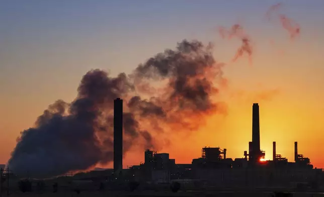 FILE - A coal-fired power plant is silhouetted against the morning sun on July 27, 2018, in Glenrock, Wyo. As he tries to secure his legacy, President Joe Biden has unleased a flurry of election-year rules on the environment and other topics, including a landmark regulation that would force coal-fired power plants to capture smokestack emissions or shut down. (AP Photo/J. David Ake, File)