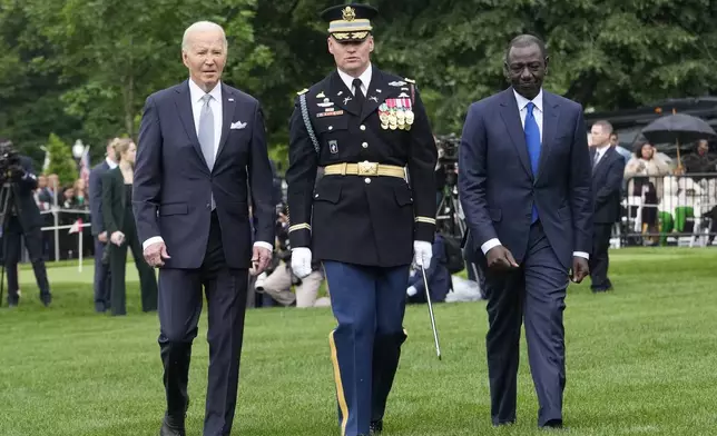 President Joe Biden, left, and Kenya's President William Ruto, right, review the troops with Col. David Rowland, commander of the 3rd U.S. Infantry Regiment, The Old Guard, during a State Arrival Ceremony on the South Lawn of the White House in Washington, Thursday, May 23. 2024. (AP Photo/Jacquelyn Martin)