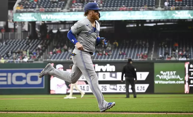 Toronto Blue Jays' Justin Turner runs home to score on a fielder's choice hit into by Daniel Vogelbach during the first inning of a baseball game, against the Washington Nationals, Saturday, May 4, 2024, in Washington. (AP Photo/Nick Wass)