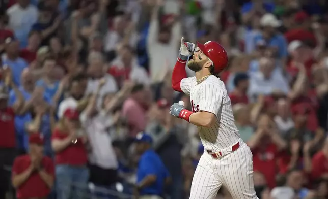 Philadelphia Phillies' Bryce Harper reacts after hitting a grand slam against Toronto Blue Jays pitcher Jose Berrios during the fourth inning of a baseball game, Tuesday, May 7, 2024, in Philadelphia. (AP Photo/Matt Slocum)