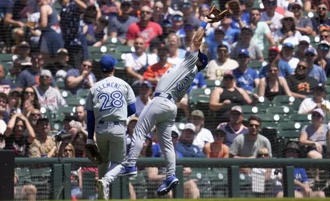 Toronto Blue Jays outfielder Davis Schneider (36) catches a Detroit Tigers' Colt Keith fly ball in foul territory as Ernie Clement (28) looks on in the fourth inning of a baseball game, Saturday, May 25, 2024, in Detroit. (AP Photo/Paul Sancya)