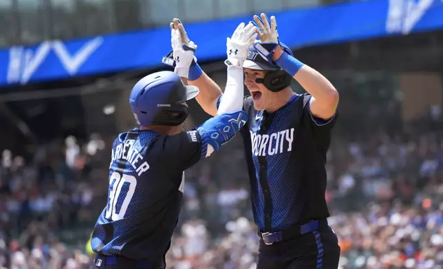 Detroit Tigers' Kerry Carpenter (30) celebrates his two-run home run with Mark Canha against the Toronto Blue Jays in the first inning of a baseball game, Saturday, May 25, 2024, in Detroit. (AP Photo/Paul Sancya)