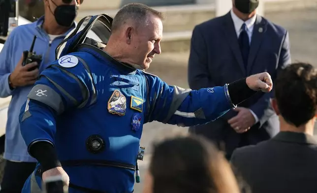 NASA astronaut Butch Wilmore gives an air fist bump to well-wishers as he leaves the Operations and Checkout building before heading to Space Launch Complex 41 to board Boeing's Starliner capsule atop an Atlas V rocket for a mission to the International Space Station at the Cape Canaveral Space Force Station Monday, May 6, 2024, in Cape Canaveral, Fla. (AP Photo/John Raoux)