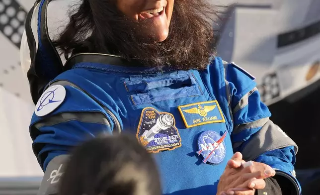 NASA astronaut Suni Williams laughs with relatives as she leaves the Operations and Checkout building before heading to Space Launch Complex 41 to board the Boeing's Starliner capsule atop an Atlas V rocket for a mission to the International Space Station at the Cape Canaveral Space Force Station, Monday, May 6, 2024, in Cape Canaveral, Fla. (AP Photo/John Raoux)