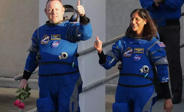 NASA astronauts Butch Wilmore, left, and Suni Williams leave the Operations and Checkout building before heading to Space Launch Complex 41 to board Boeing's Starliner capsule atop an Atlas V rocket for a mission to the International Space Station at the Cape Canaveral Space Force Station, Monday, May 6, 2024, in Cape Canaveral, Fla. (AP Photo/John Raoux)