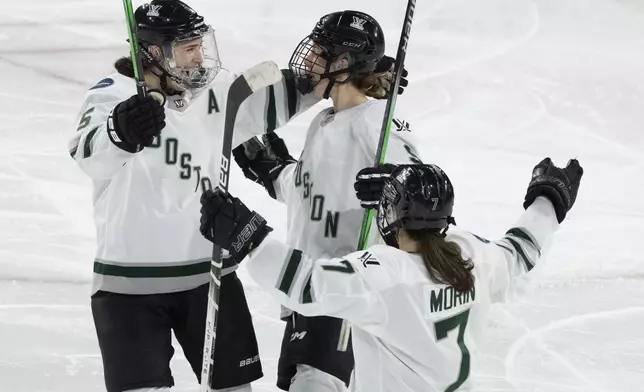 Boston's Sophie Shirley, centre, celebrates her goal against Montreal with Megan Keller (5) and Sidney Morin (7) during the third period of Game 1 of a PWHL hockey playoff series Thursday, May 9, 2024, in Montreal. (Christinne Muschi/The Canadian Press via AP)
