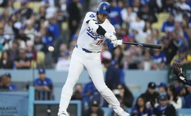 Los Angeles Dodgers designated hitter Shohei Ohtani doubles during the fourth inning of a baseball game against the Atlanta Braves in Los Angeles, Saturday, May 4, 2024. Gavin Lux scored. (AP Photo/Ashley Landis)