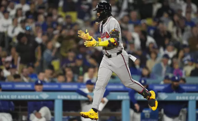 Atlanta Braves' Ronald Acuna Jr. runs the bases after hitting a home run during the eighth inning of a baseball game against the Los Angeles Dodgers in Los Angeles, Friday, May 3, 2024. (AP Photo/Ashley Landis)