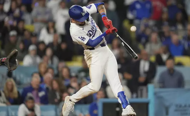 Los Angeles Dodgers' Andy Pages singles during the eleventh inning of a baseball game against the Atlanta Braves in Los Angeles, Friday, May 3, 2024. Will Smith scored. The Dodgers won 4-3. (AP Photo/Ashley Landis)