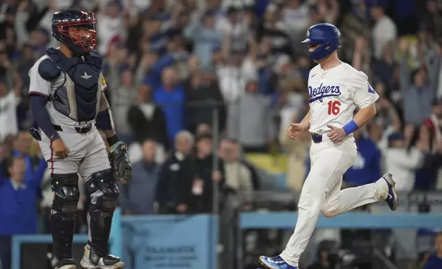 Los Angeles Dodgers' Will Smith (16) scores on a walk-off single hit by Andy Pages during the eleventh inning of a baseball game against the Atlanta Braves in Los Angeles, Friday, May 3, 2024. The Dodgers won 4-3. (AP Photo/Ashley Landis)