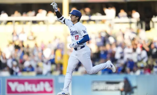 Los Angeles Dodgers designated hitter Shohei Ohtani (17) runs the bases after hitting a home run during the third inning of a baseball game against the Atlanta Braves in Los Angeles, Saturday, May 4, 2024. (AP Photo/Ashley Landis)