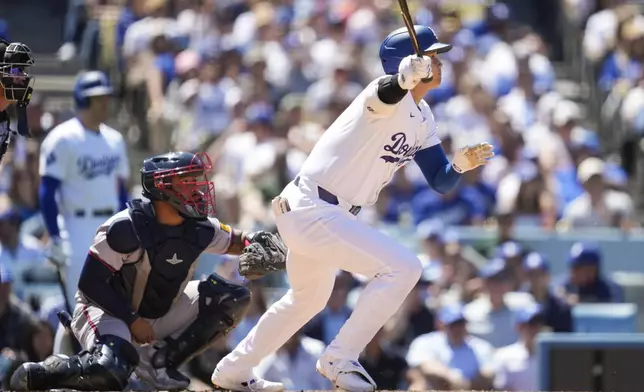 Los Angeles Dodgers designated hitter Shohei Ohtani (17) singles during the sixth inning of a baseball game against the Atlanta Braves in Los Angeles, Sunday, May 5, 2024. (AP Photo/Ashley Landis)